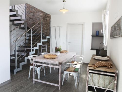 a dining room with a table and a staircase at CA' DA TOLLO in Cogorno