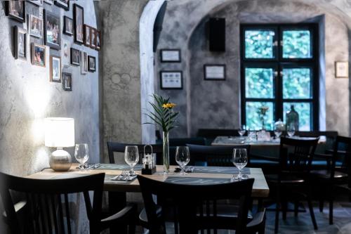 a restaurant with a table and chairs and a window at Oliva Hotel in Veszprém