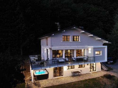 an aerial view of a house at night at Vue exceptionnelle sur lac d'Annecy et Montagnes in Menthon-Saint-Bernard