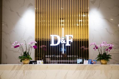 a store window with a de sign and purple flowers at D&F BOUTIQUE HOTEL SEREMBAN 2 in Seremban
