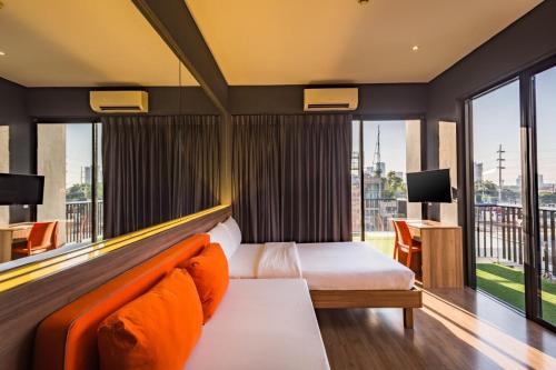 a hotel room with a bed and a large window at Azumi Boutique Hotel in Manila