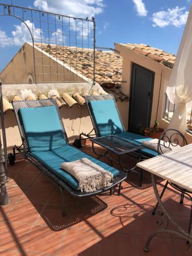 two chairs and a table on a patio at Villa in Gargano - VILLA BASSO in Monte SantʼAngelo