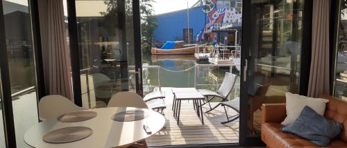 a room with a balcony with tables and chairs at La Mare Resort in Gothenburg