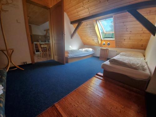 a small room with two beds in a cabin at Farma Malenice in Malenitz