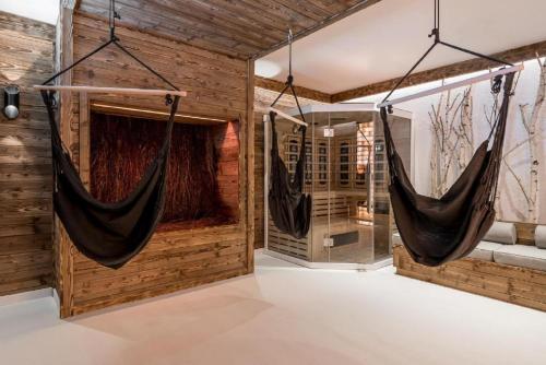a room with two hammocks hanging from the wall at Osada Szeligówka - Premium Chalets Kościelisko in Kościelisko