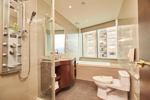 a bathroom with a toilet and a sink and a shower at Hotel HD Palace in Taipei