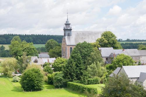 an aerial view of an old church with a tower at B&B Le Vieux Marronnier in Foy-Notre-Dame