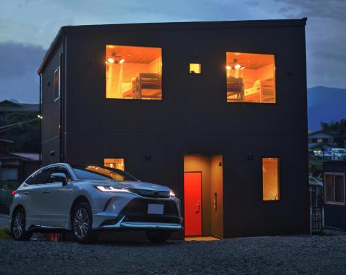 a car parked in front of a black house at Fuji Time Traveler 玉手箱 in Fujikawaguchiko