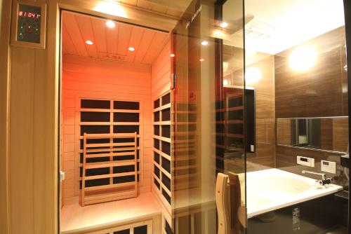 a bathroom with a glass shower and a sink at Fuji Time Traveler 玉手箱 in Fujikawaguchiko