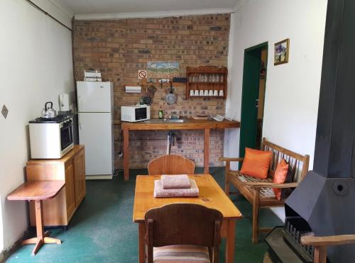 a kitchen with a table and a refrigerator at Guesthouse 914 in Sabie