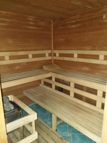 a sauna with wooden walls and benches in it at Wellness Hotel Haná in Mariánské Lázně