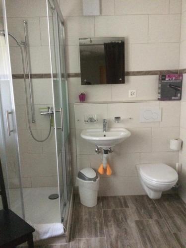 a bathroom with a sink and a toilet and a shower at Casa Riposo in Flumserberg