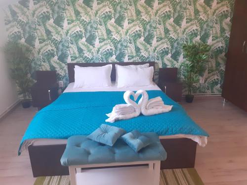 a bed with two white swans sitting on it at Casa Lions in Timişoara