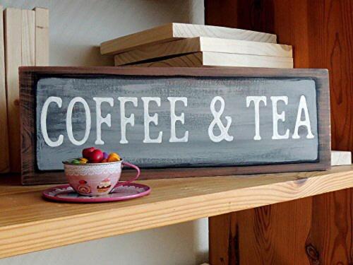 a sign that says coffee and tea on a shelf at Roza Hotel Apartments in Muscat