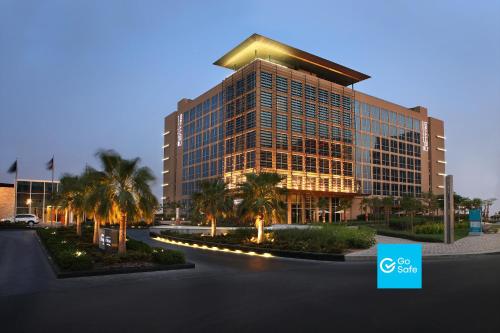 a rendering of a building with palm trees in front of it at Centro Yas Island-by Rotana in Abu Dhabi