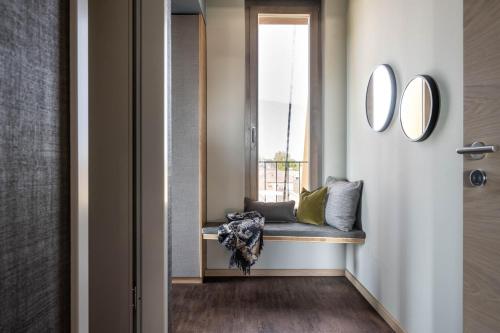 a hallway with a bench and a window at Hotel Maier in Friedrichshafen