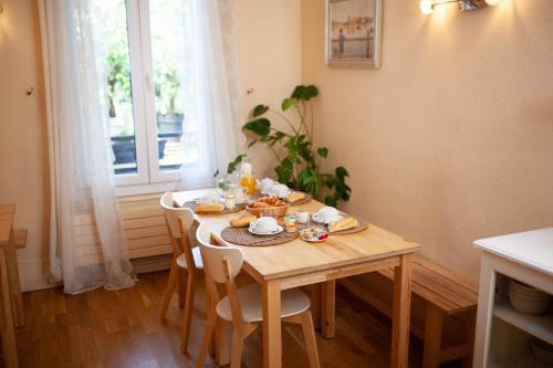 a wooden table with food on it in a room with a window at H&ocirc;tel du Parc in Choisy-le-Roi