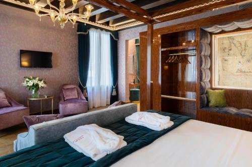 
a hotel room with two beds and a mirror at Hotel Donà Palace in Venice
