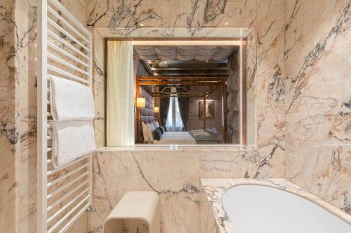 a bathroom with a toilet and a sink at Hotel Donà Palace in Venice