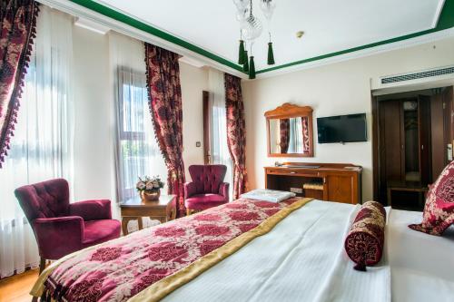 a bedroom with a bed and two chairs at Garden House Hotel - Special Class in Istanbul