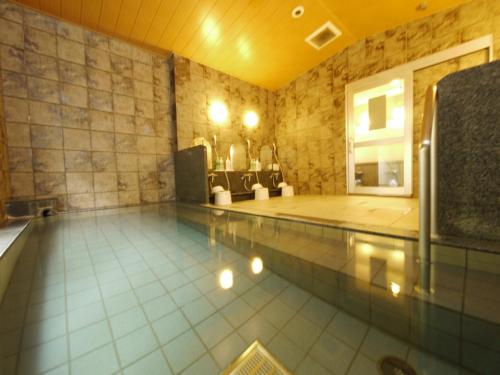 a large swimming pool with a pool at Hotel Route-Inn Shibukawa in Shibukawa