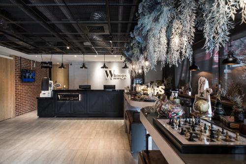 a room with a bar with a counter with a chessboard at Whoops Hotel in Taichung