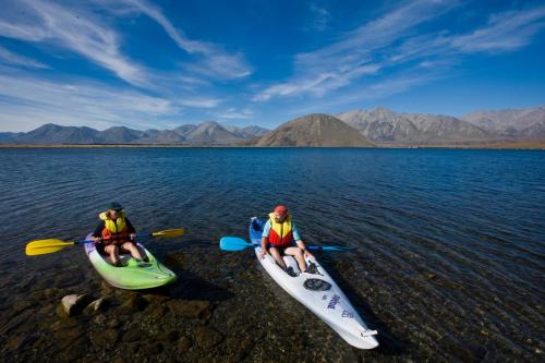 two people sitting in kayaks on a body of water at Taylors Motel in Ashburton
