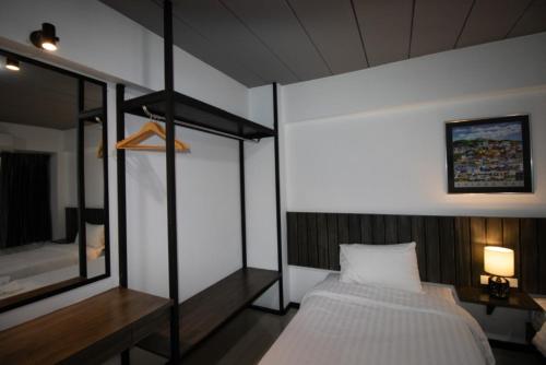 a bedroom with a bunk bed and a mirror at The 168 Gallery Residence and Hotel in Chiang Mai