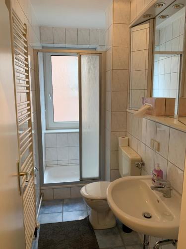 a bathroom with a toilet and a sink at City Studio Apartment in Bremerhaven