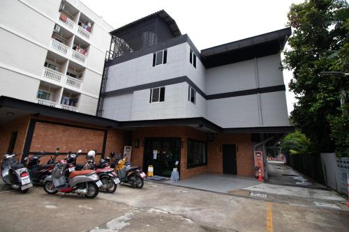 a group of motorcycles parked in front of a building at The 168 Gallery Residence and Hotel in Chiang Mai