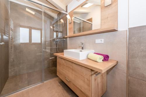a bathroom with a sink and a shower at Pension Niederreiter in Maria Alm am Steinernen Meer