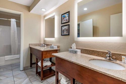 a bathroom with two sinks and a large mirror at Comfort Inn Lafayette I-65 in Lafayette