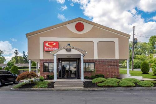 a building with a sign on the front of it at Econo Lodge Dewitt I-90 in DeWitt