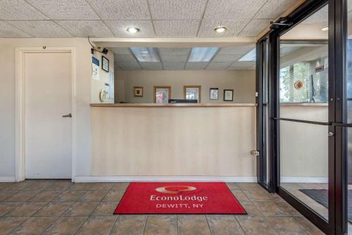 a lobby with a red welcome mat on the floor at Econo Lodge Dewitt I-90 in DeWitt