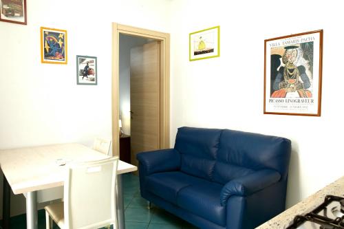 a blue couch sitting in a room with a table at Fardella 250 in Trapani