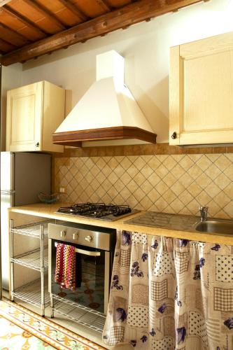 a kitchen with a stove and a hood at Fardella 250 in Trapani