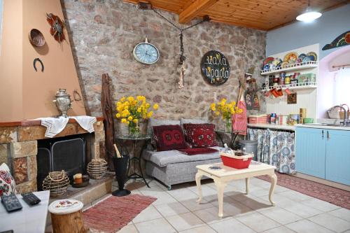 a living room with a couch and a fireplace at Kalavrita Winter Retreat - Homely Spacious Chalet in Áno Vlasía