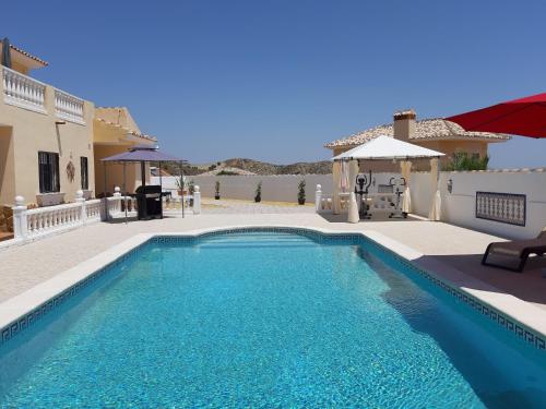 a swimming pool in front of a house at Los Torres Casa Lindsay in Arboleas