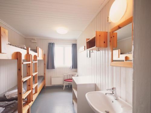 a bathroom with a sink and a bunk bed at Preikestolen BaseCamp in Jørpeland