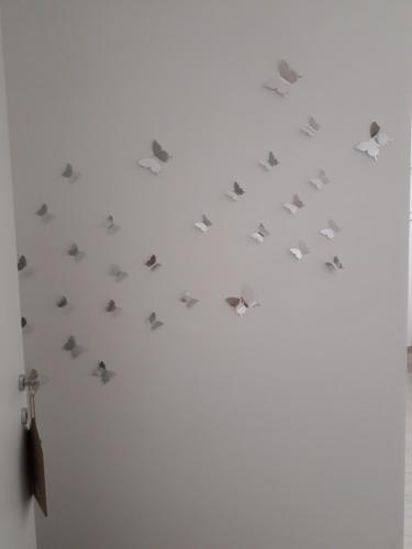 a group of butterflies on a white wall at b&b Il Sorriso in Pozzilli