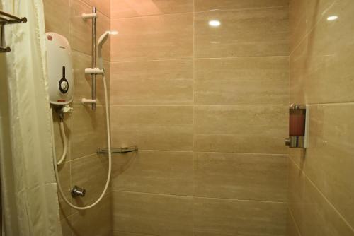 a bathroom with a shower with a shower at Sunrise Hotel in Petaling Jaya