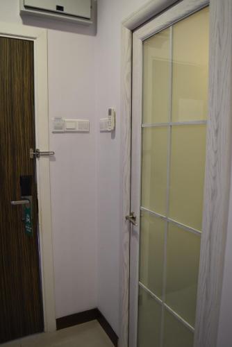 a glass door to a shower in a room at Sunrise Hotel in Petaling Jaya
