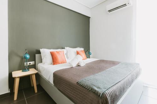 a bedroom with a large bed with orange pillows at Athens Studios in Athens