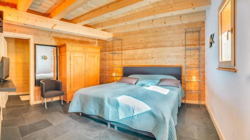 a bedroom with a bed in a wooden room at Les 4 Chamois - Chalet - BO Immobilier in Abondance