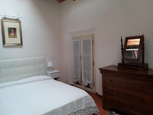 a bedroom with a bed and a mirror and a dresser at Sweet Home in Imola