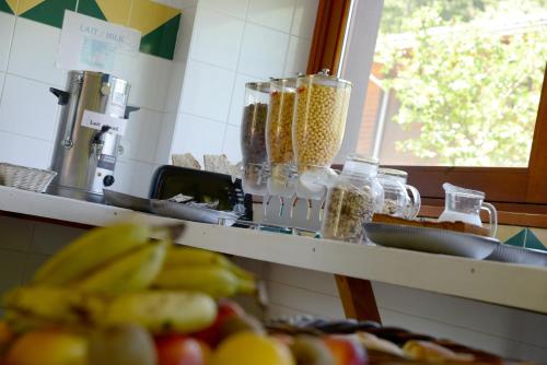 a counter top with a bunch of fruits and vegetables at Auberge de Jeunesse HI Séez in Séez