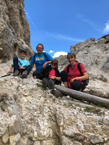 a group of people sitting on a rocky mountain at Surega - Idyllic Farmhouse in San Cassiano