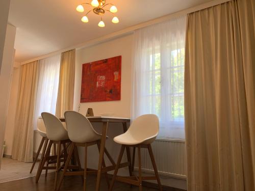 a dining room with a table and chairs and a window at Chez Nous en fait in Salzburg