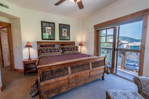 a bedroom with a large bed and a large window at Town Point Condos by Park City Vacations in Park City