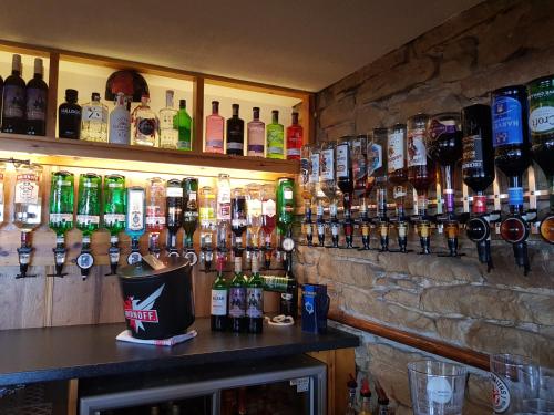 a bar with a bunch of bottles of alcohol at Balintore Inn in Balintore